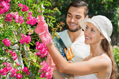 Gardener inspecting a hedge in Chiswick